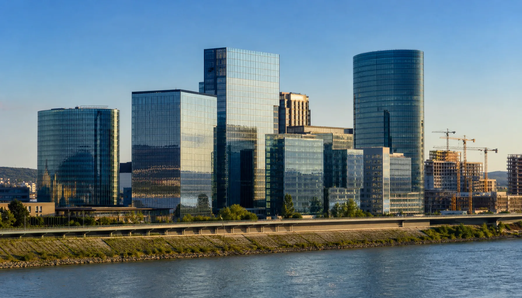 Glass office towers of Bratislava's Mlynské nivy district rising above the Danube embankment