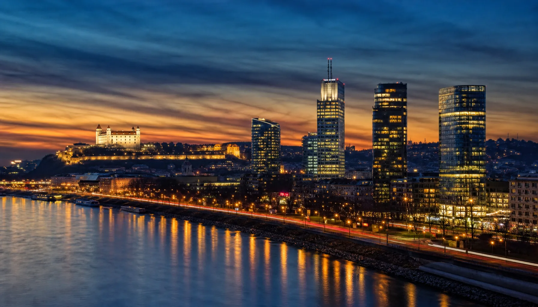 Bratislava's skyline above the Danube — the castle, the UFO bridge and the towers of a capital an hour from Vienna