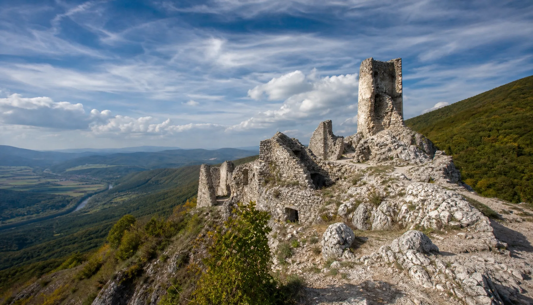 Roofless walls and the stump of the tower on the bare summit