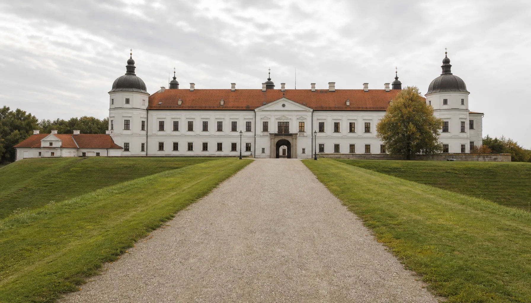 The level approach across the rampart lawn to the roofed baroque château at Holíč