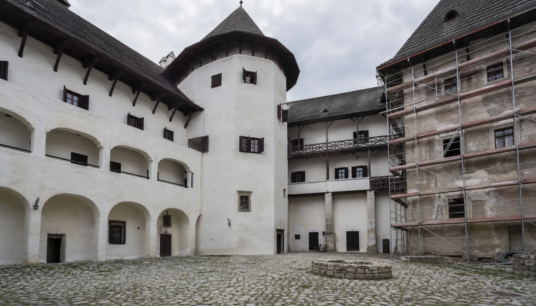 The courtyard, with restored wings standing beside ranges still waiting their turn