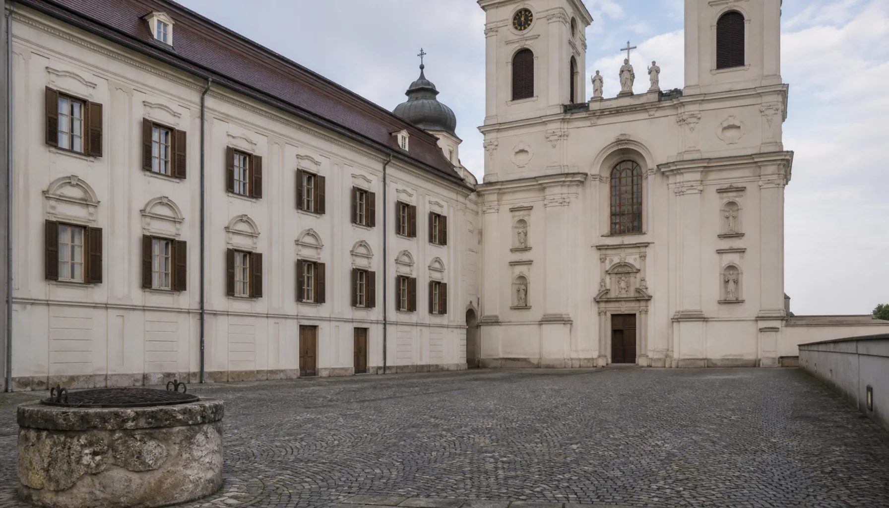 The white Baroque front of the bishop's palace across the castle courtyard