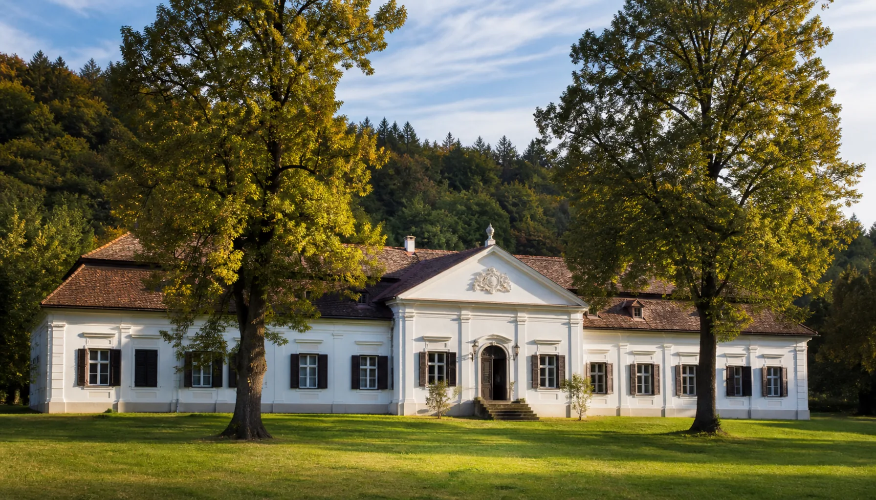 The restored Apponyi manor in the village, with its park behind