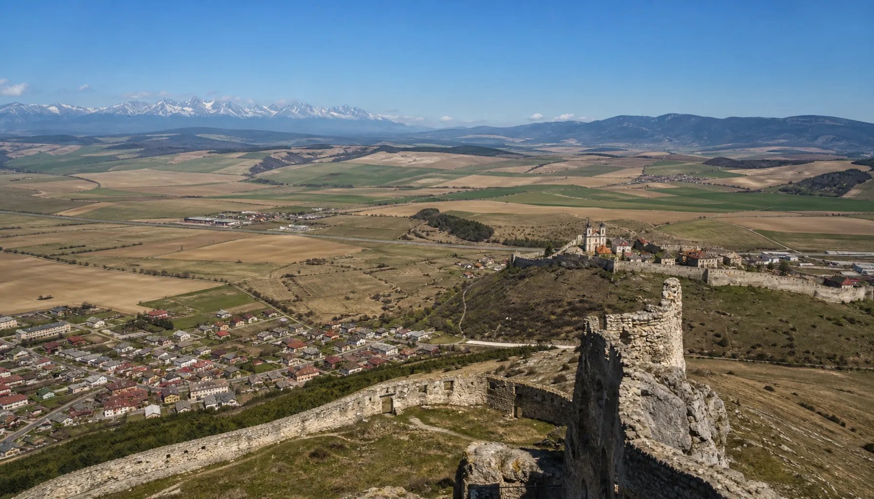 The view from the upper tower: the Spiš basin, the Branisko ridge to the east and the High Tatras on the far horizon