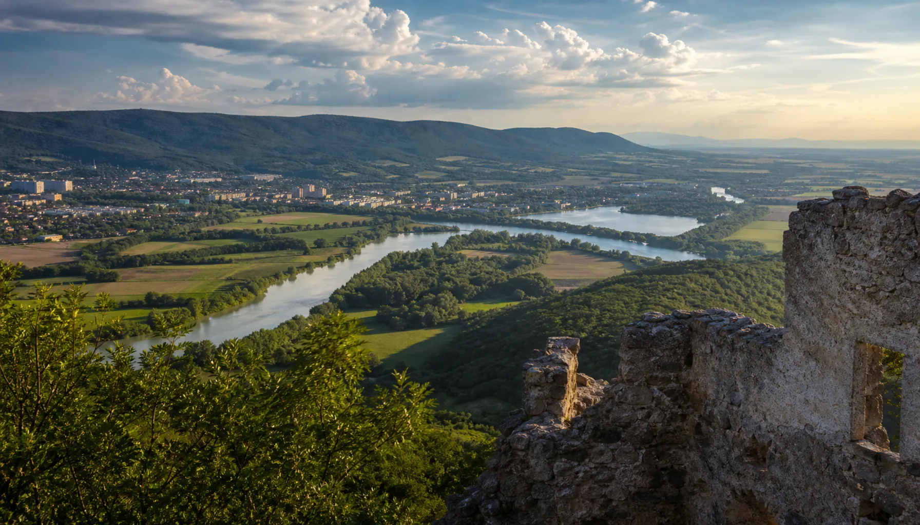 West from the walls: the Váh valley, Piešťany, and the Little Carpathians behind