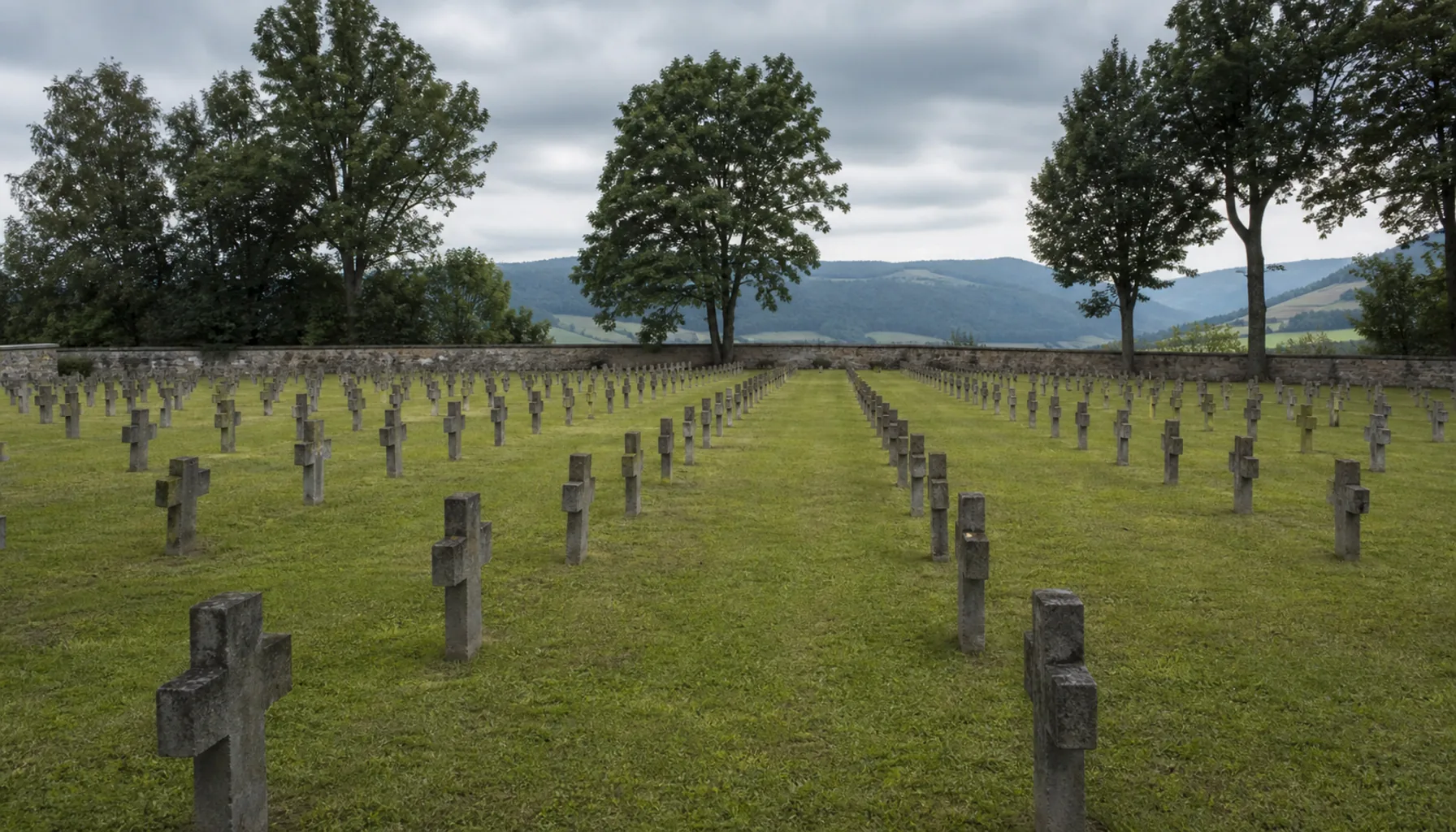 The First World War military cemetery below the castle — rows of plain crosses in mown grass