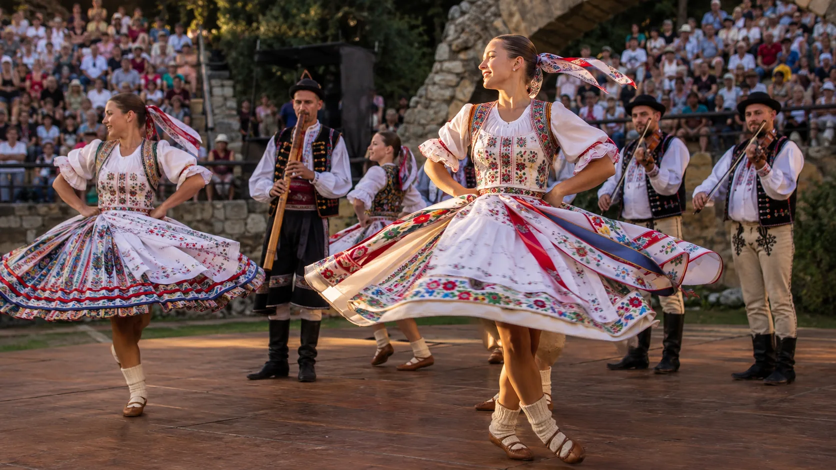 Embroidered kroj in motion at a summer folklore festival