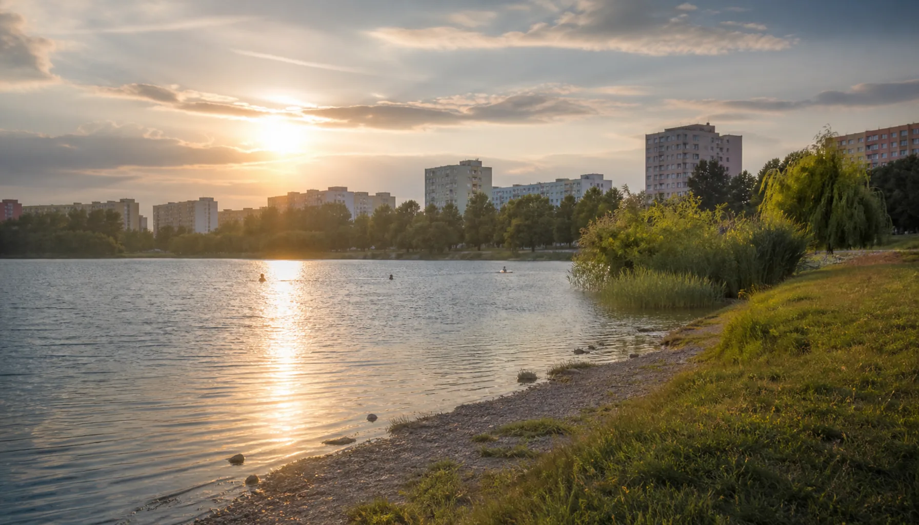 Summer evening at Jazero, the lake that named the Nad jazerom district, with the housing blocks standing back from the shore