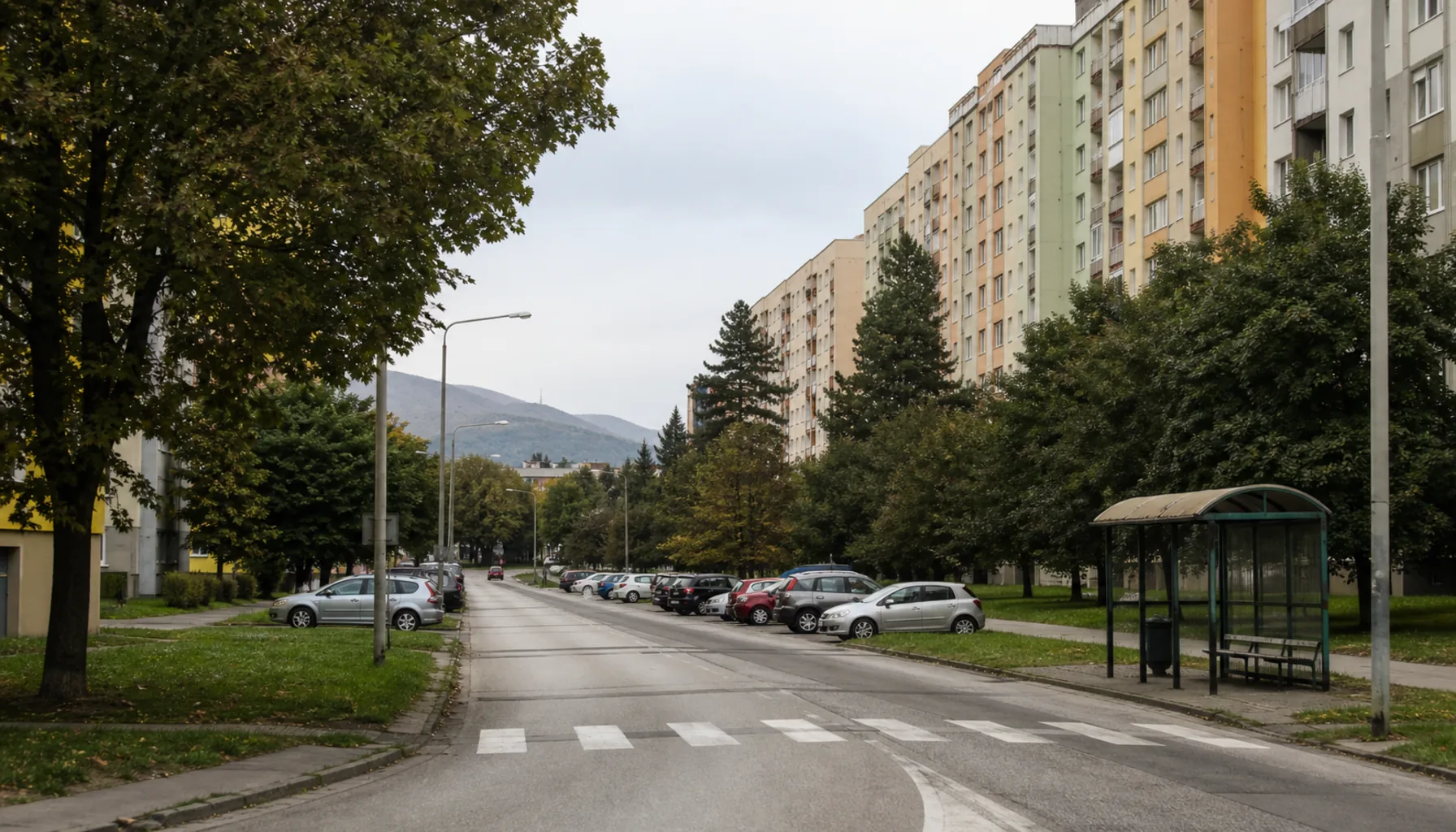 The Chrenová district on an ordinary weekday — housing blocks, mature trees and wide 1970s streets east of the river
