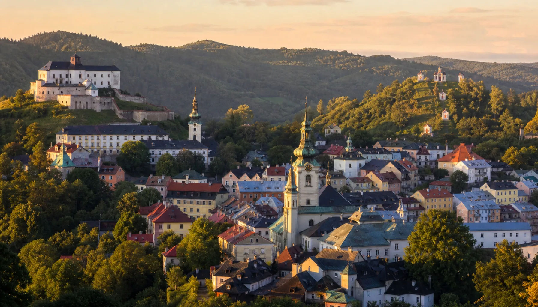 The stacked pastel streets of Banská Štiavnica in its valley, south of Zvolen in the old mining hills