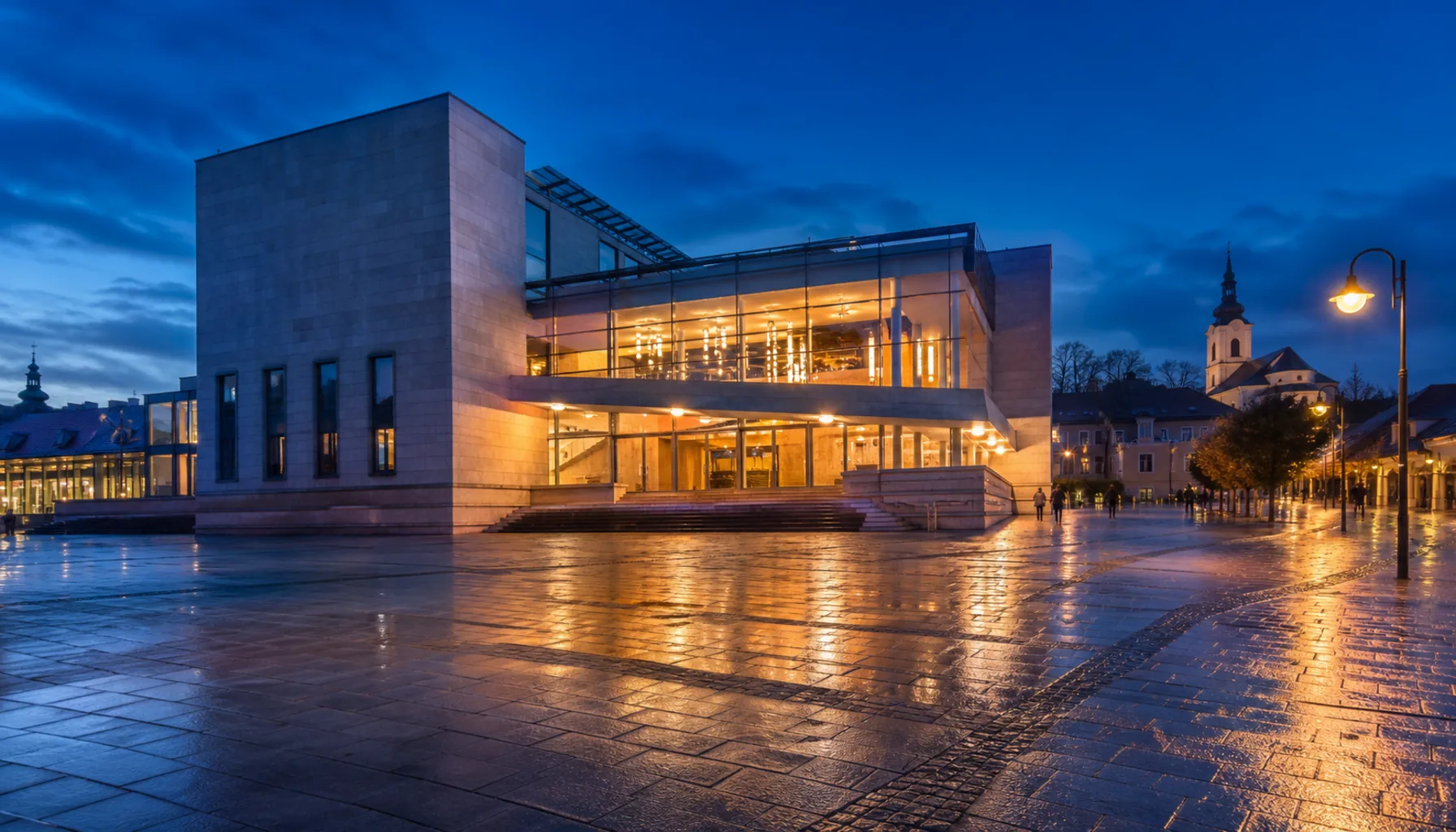 The Andrej Bagar Theatre lit up on the main square of the lower town