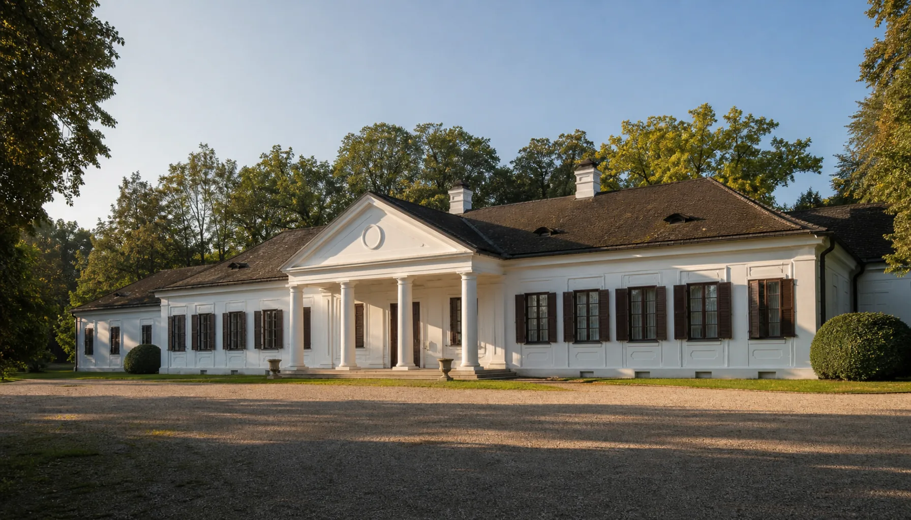 The classicist manor house at the heart of Ivanka pri Nitre, with its park of old trees behind