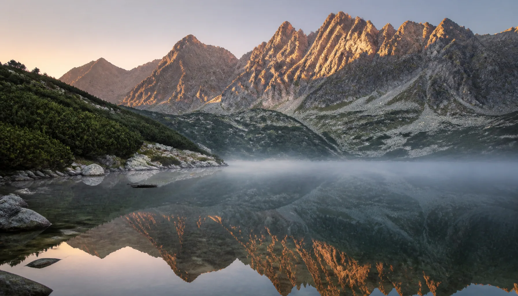 A glacial tarn mirrors the granite crests of the High Tatras — the heart of the country’s oldest national park