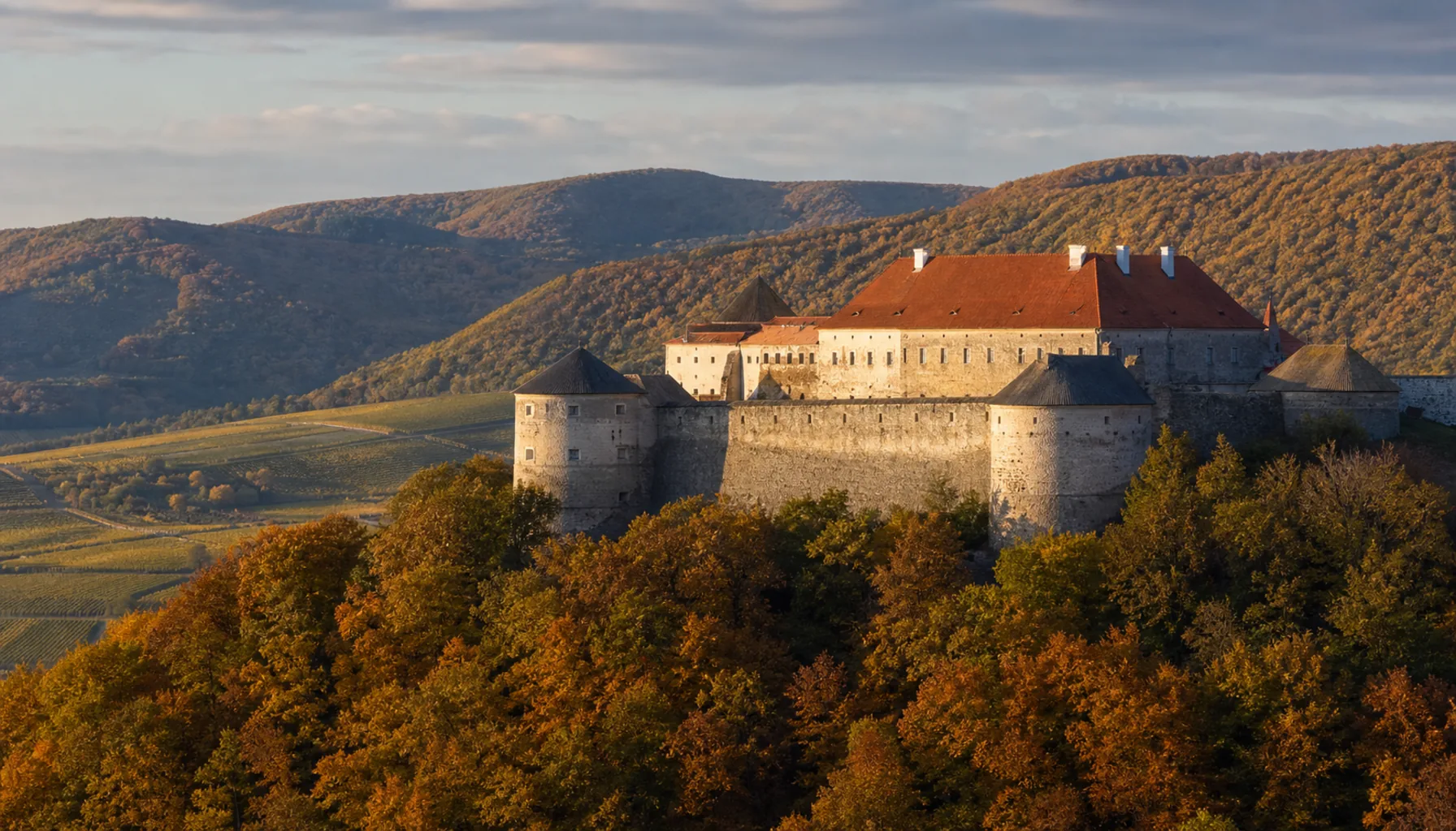 The bastioned block of Červený Kameň castle standing among the wooded slopes of the Little Carpathians