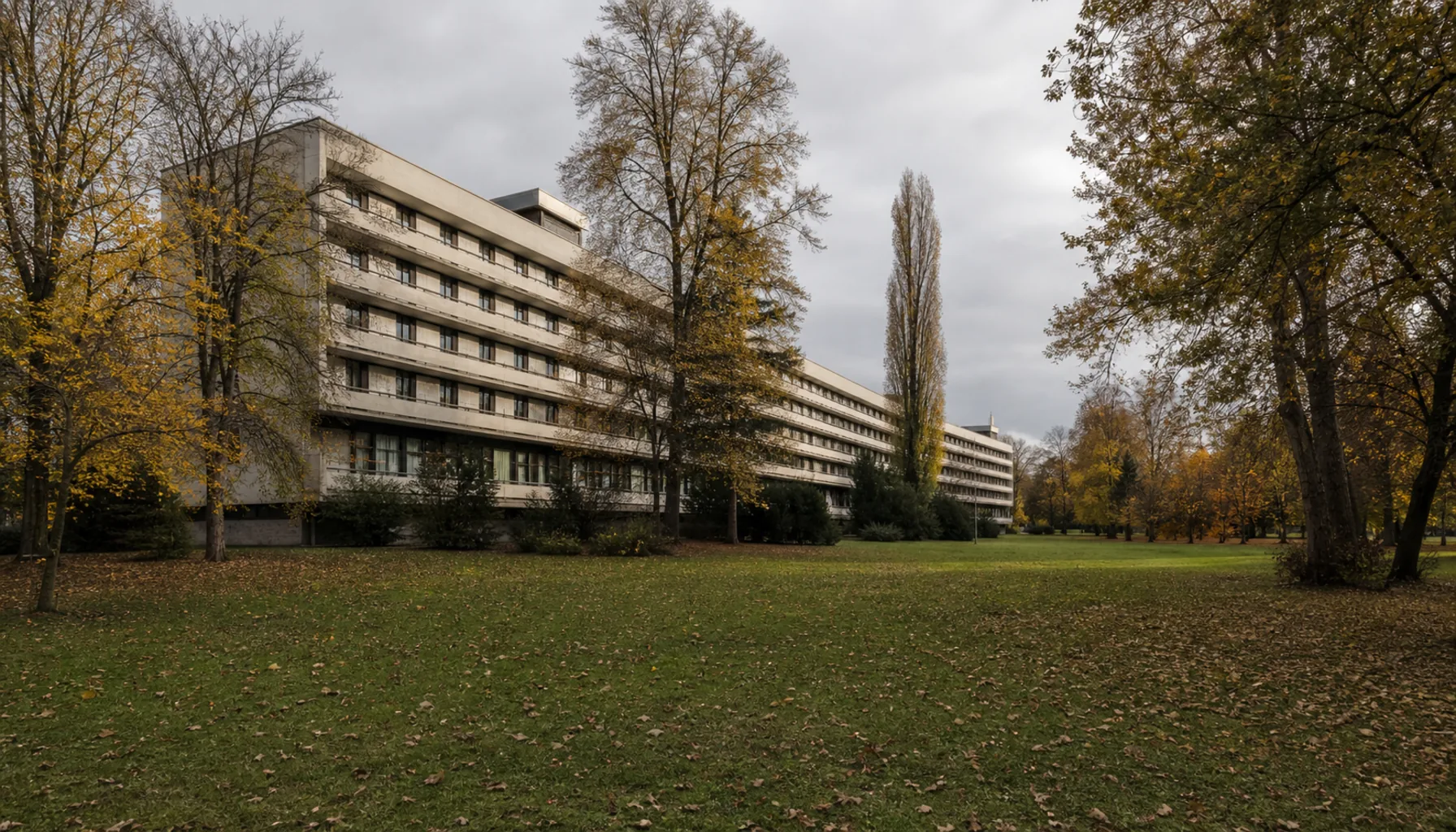 The long concrete spa houses built to deliver treatment at scale, set among the island's parkland