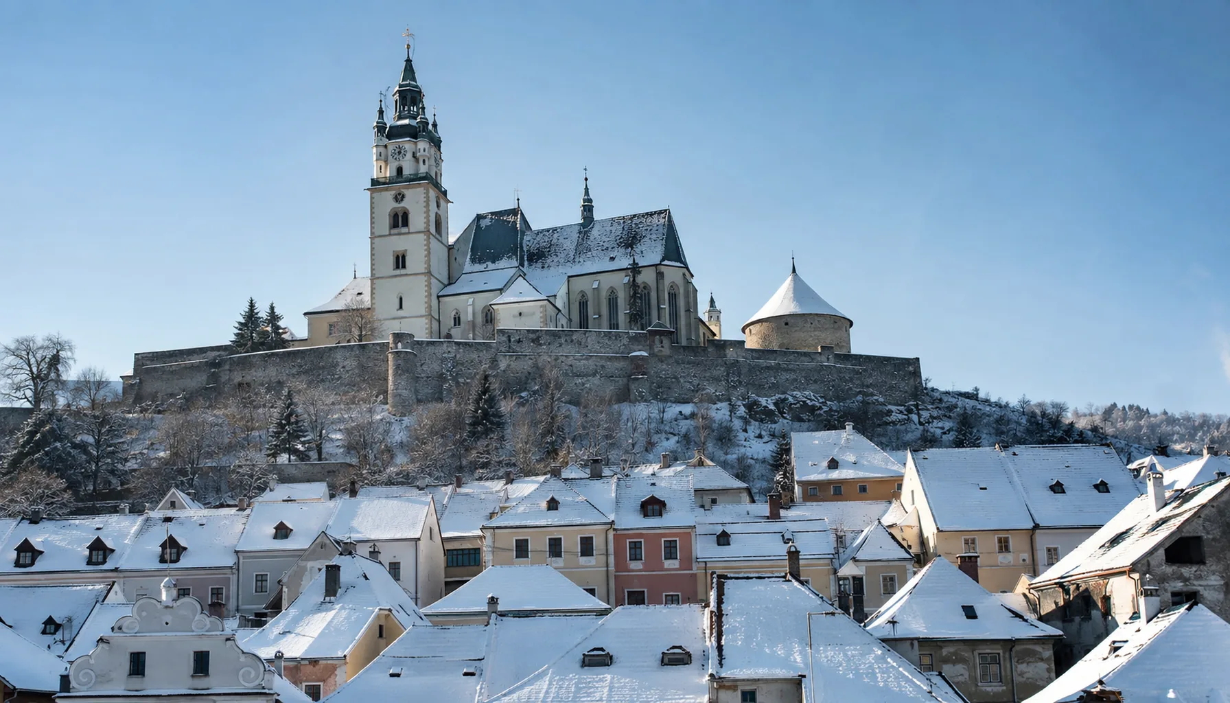 Kremnica's walled town castle above the square, with the Gothic Church of St Catherine and the round charnel chapel inside its precinct
