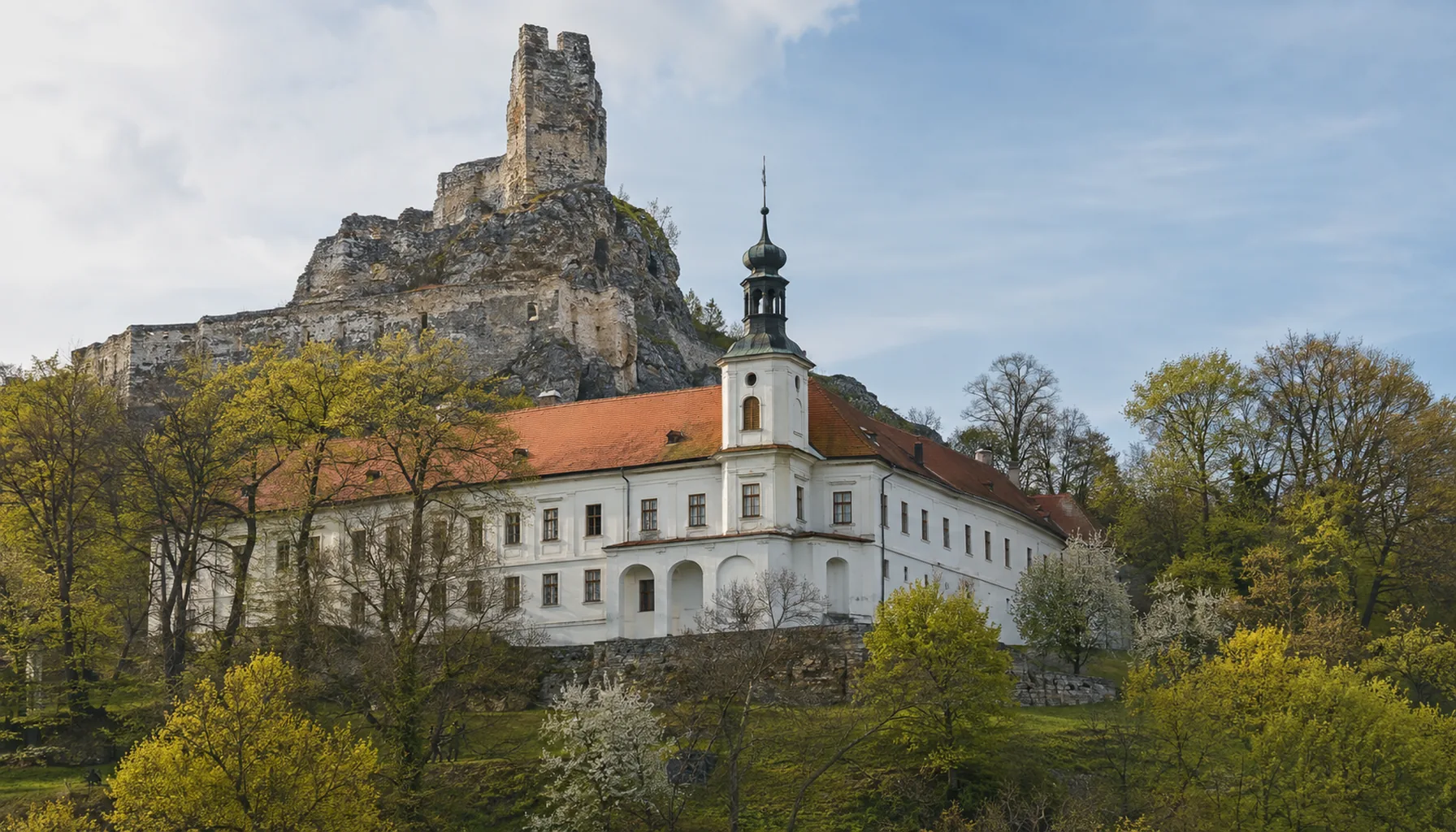 The Baroque mansion at Modrý Kameň, built across the lower ward of the old frontier castle, with the ruined upper walls on the rock above it