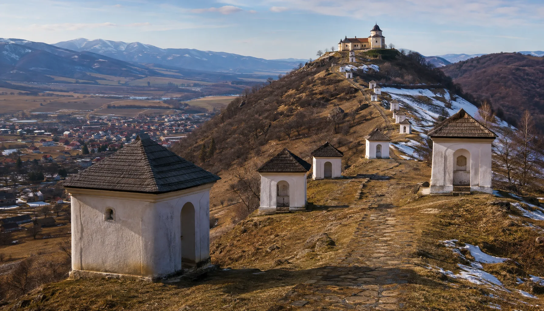 The Baroque calvary above Nová Baňa, a line of chapels climbing the hill to the church on its summit, with the Hron valley below
