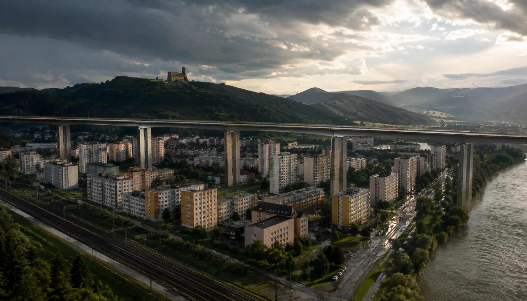 The D1 motorway viaduct crossing the centre of Považská Bystrica on its piers, with the castle ridge on the skyline behind it