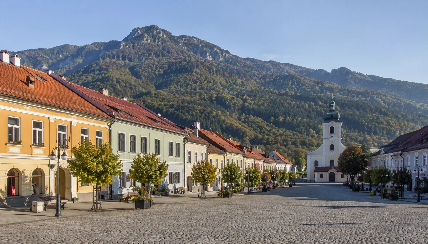 The broad market square of Rajec under the wooded Malá Fatra