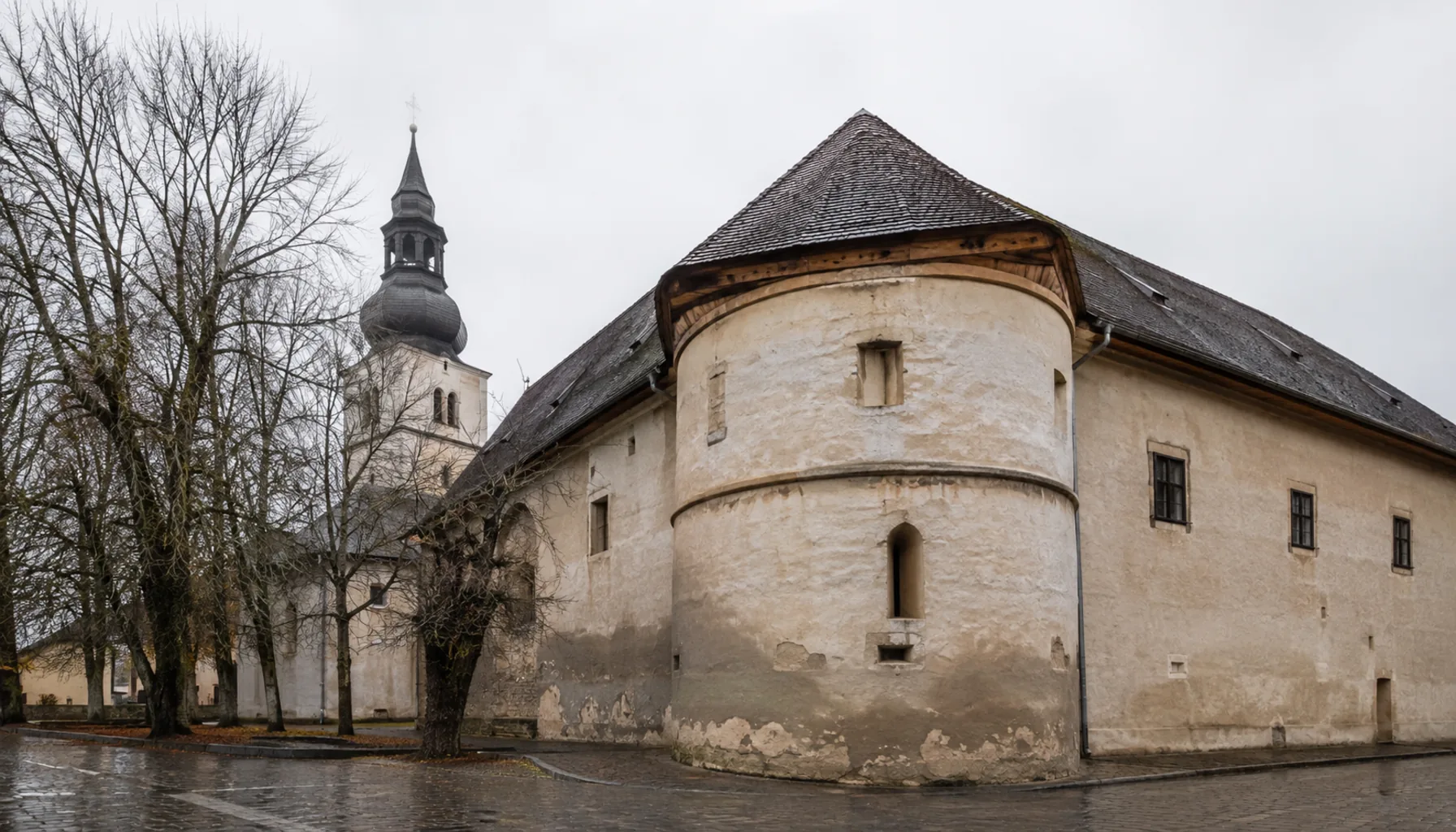 The surviving wing of Stropkov's Renaissance fortified manor, standing beside the Gothic parish church at the centre of the town