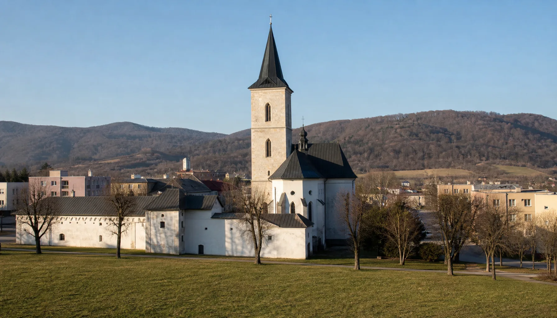 The parish church at Stropkov, with the surviving wing of the Renaissance manor beside it