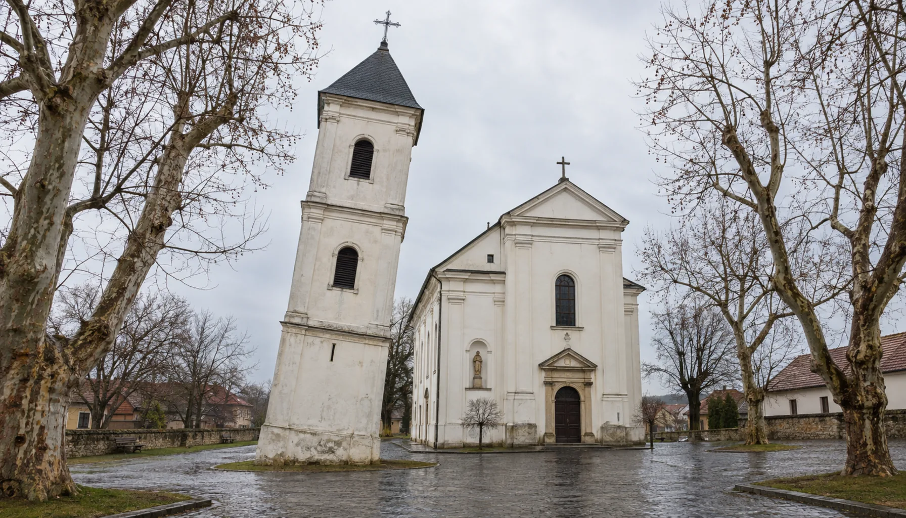 The Classicist bell tower at Vrbové, which has leaned close to a metre out of true since the rains of 1930, beside the church of St Martin