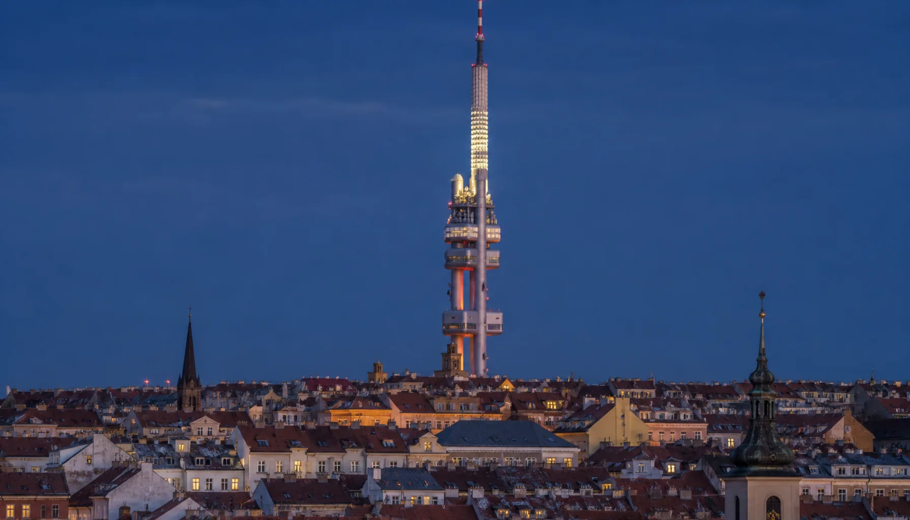 The Žižkov television tower above the rooftops of Prague
