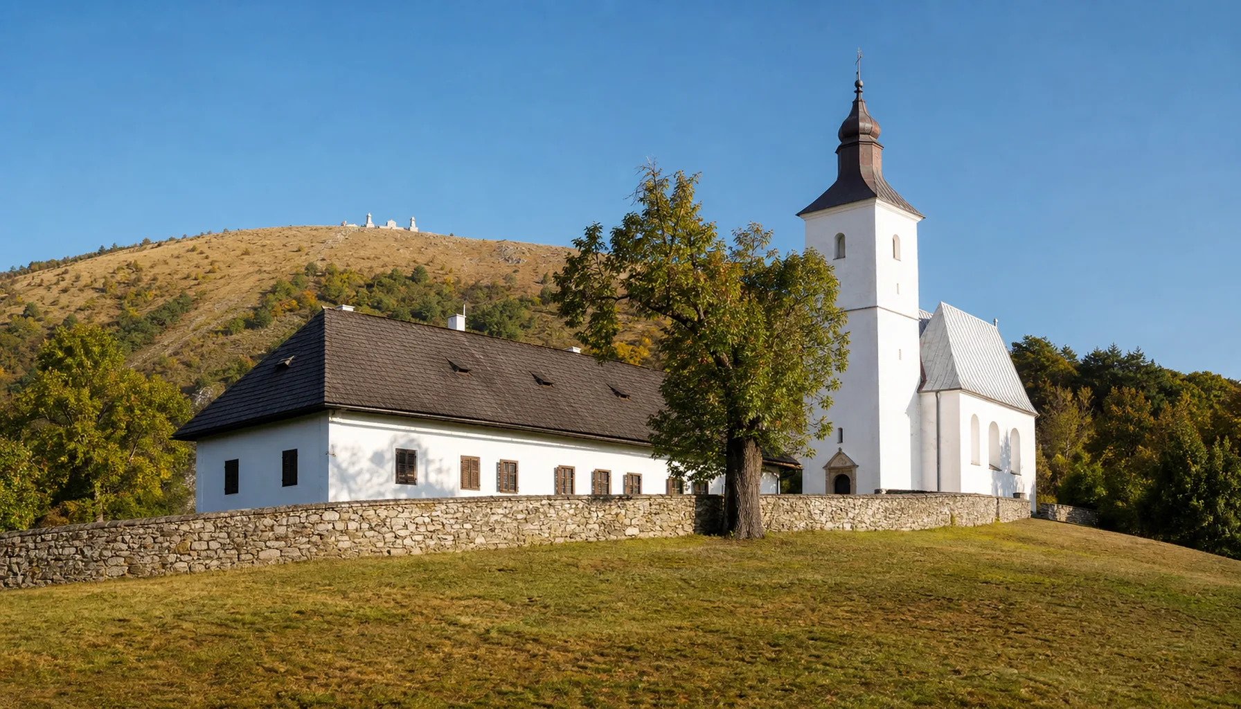 The Lutheran parish house at Košariská, the church beside it and Bradlo behind