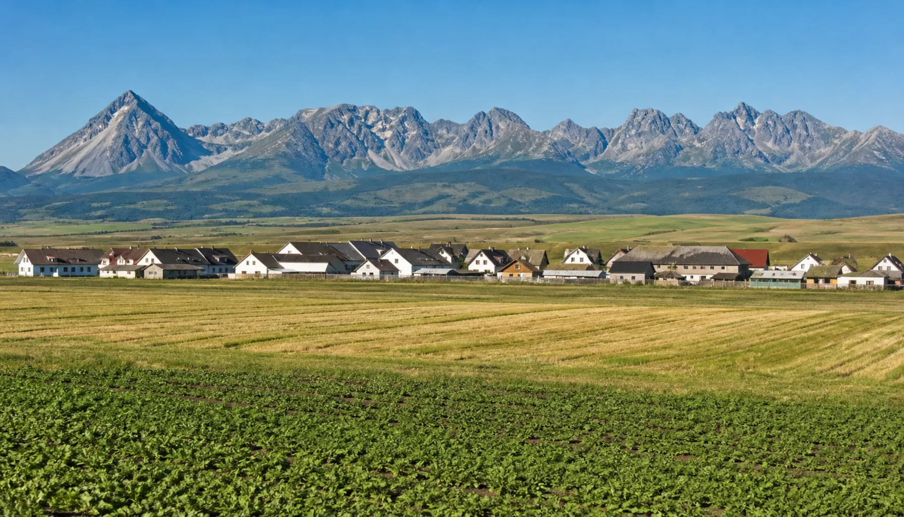 The village of Štrba on its saddle with the High Tatra ridge behind