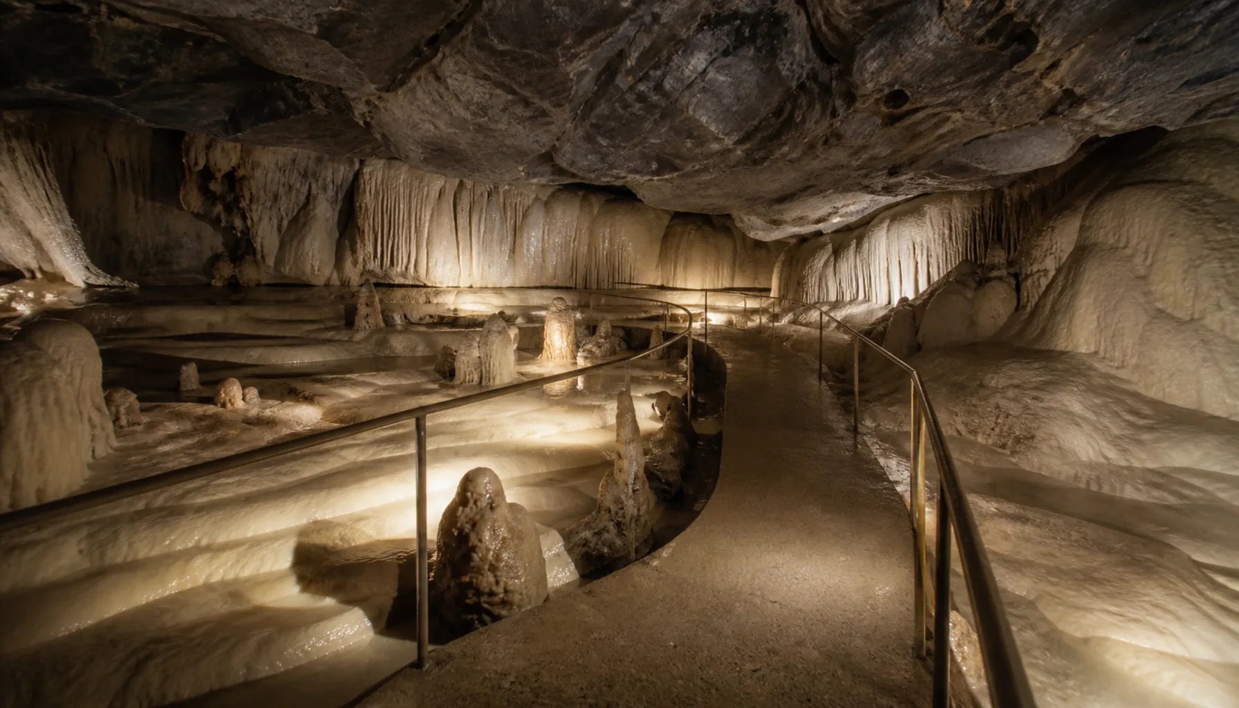 Pale sinter formations in a low chamber of the Važec cave
